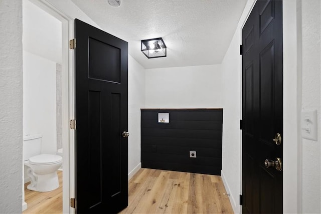 15015 E Truman Rd, Independence, MO 64050 - hallway with a textured ceiling, baseboards, and light wood finished floors