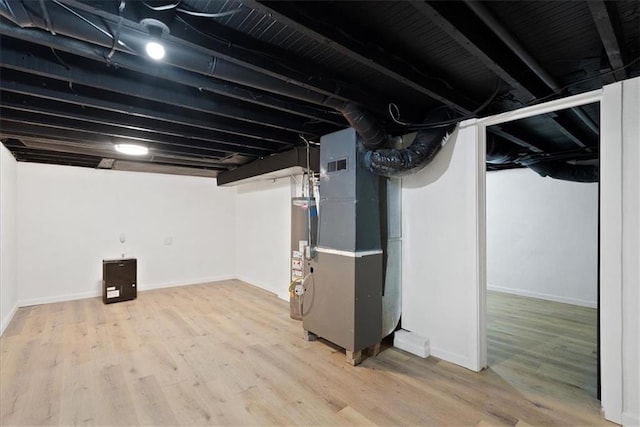 15015 E Truman Rd, Independence, MO 64050 - finished basement with heating unit, baseboards, gas water heater, and wood finished floors