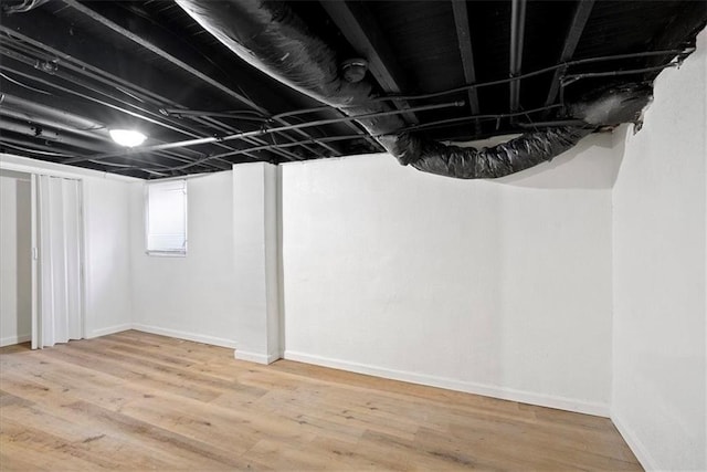15015 E Truman Rd, Independence, MO 64050 - basement featuring baseboards and wood finished floors