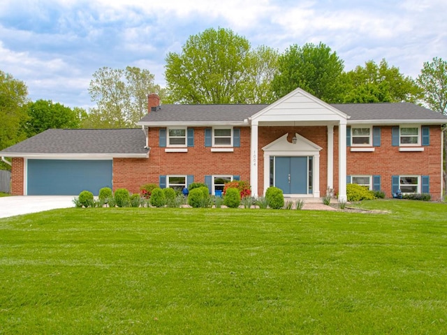 1004 Tam O Shanter Dr, Kansas City, MO 64145 - raised ranch with brick siding, concrete driveway, a garage, a front lawn, and a chimney