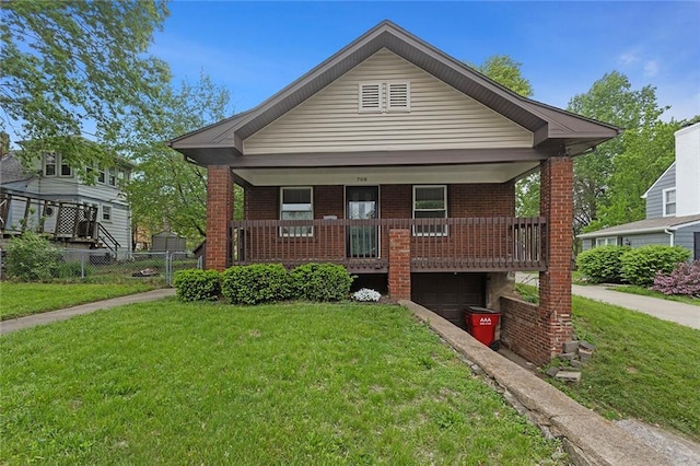 708 N River Blvd, Independence, MO 64050 - bungalow-style home featuring brick siding, an attached garage, and a front yard