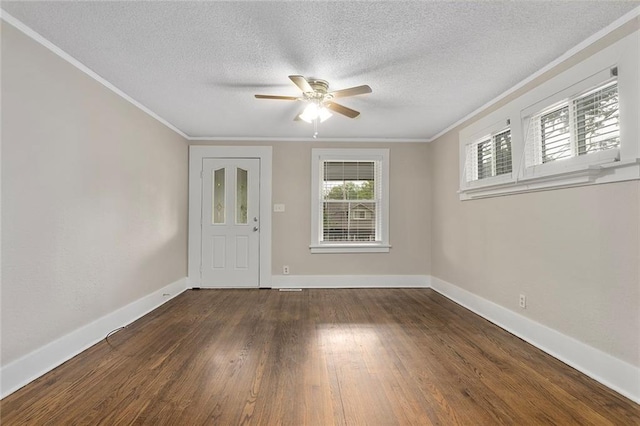 708 N River Blvd, Independence, MO 64050 - entryway featuring a ceiling fan, a textured ceiling, baseboards, ornamental molding, and dark wood-type flooring
