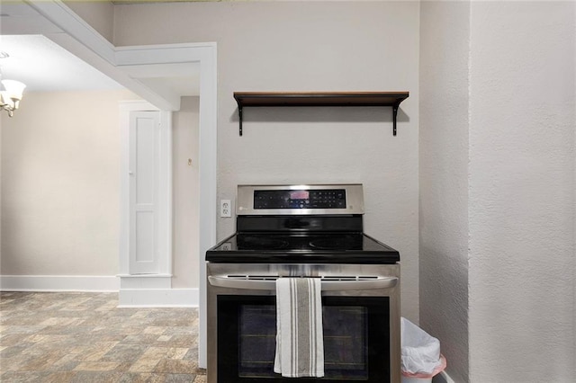 708 N River Blvd, Independence, MO 64050 - kitchen with a chandelier, stainless steel electric range, stone finish flooring, and baseboards