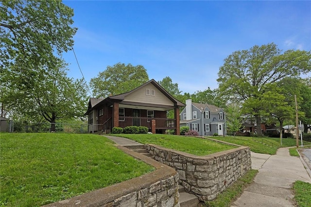 708 N River Blvd, Independence, MO 64050 - bungalow featuring a porch, brick siding, and a front yard