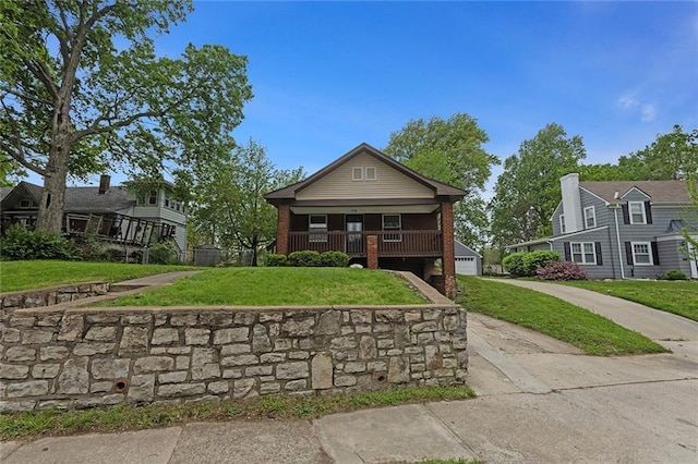 708 N River Blvd, Independence, MO 64050 - bungalow with a porch, a front yard, and a garage