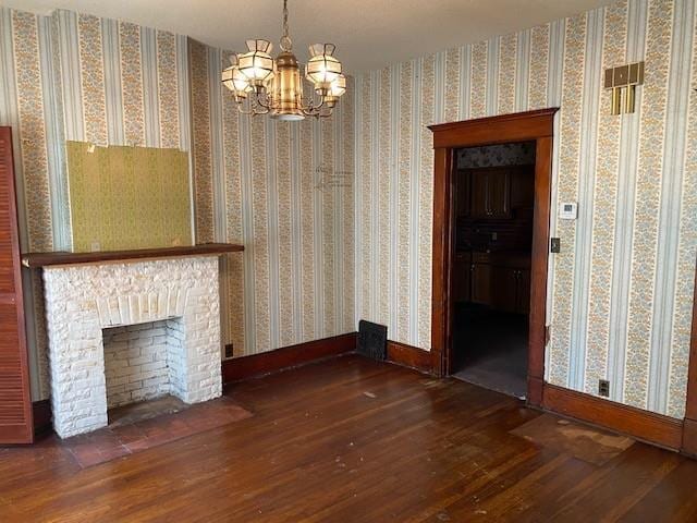 unfurnished dining area with dark wood-type flooring, baseboards, and a chandelier
