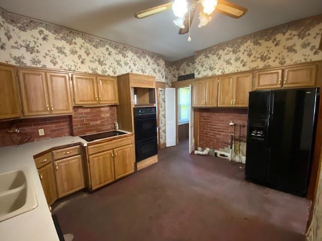 kitchen with ceiling fan, light countertops, dark colored carpet, wallpapered walls, and black appliances