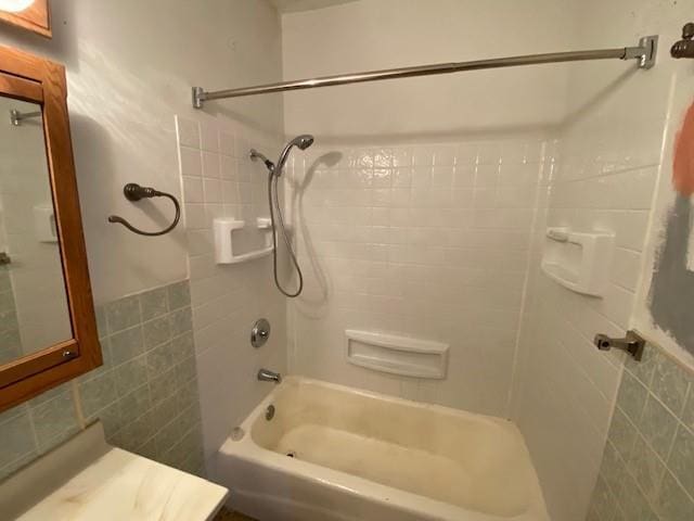 bathroom featuring tile walls and  shower combination