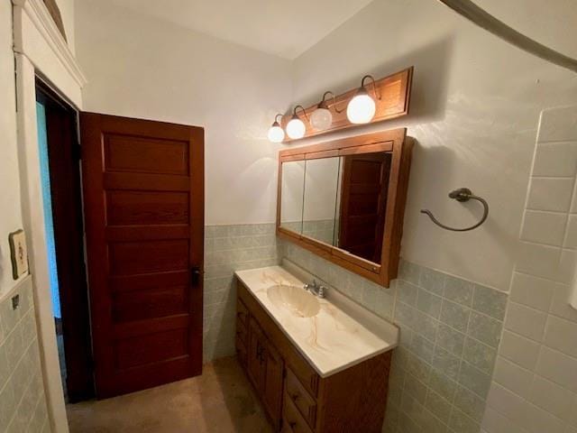 bathroom with tile walls, wainscoting, and vanity