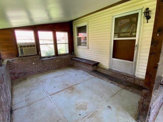 unfurnished sunroom with cooling unit and a wealth of natural light