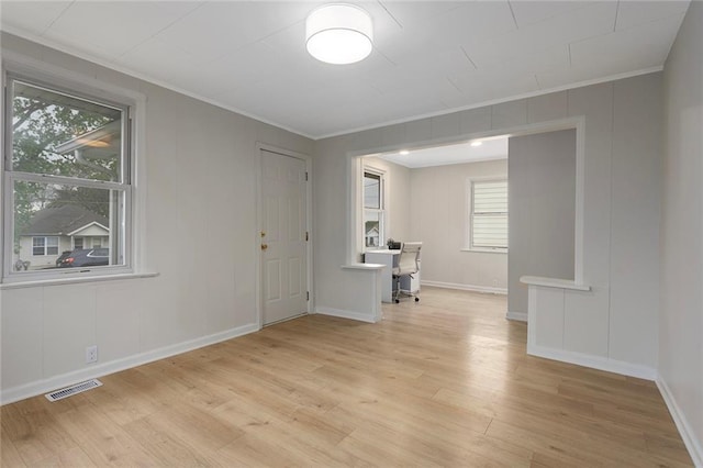 4433 N Jackson Ave, Kansas City, MO 64117 - interior space featuring baseboards, ornamental molding, light wood-type flooring, and visible vents