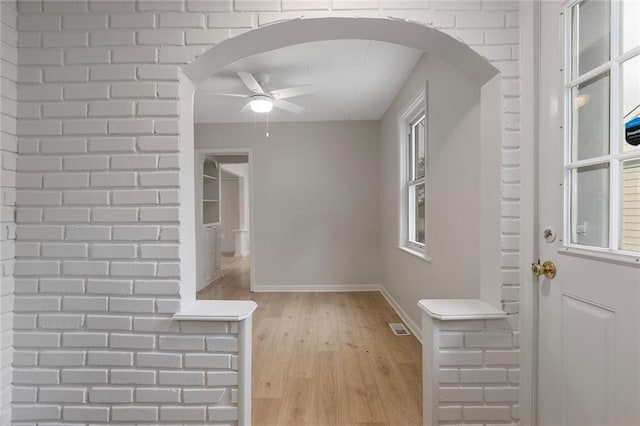 4433 N Jackson Ave, Kansas City, MO 64117 - interior space featuring light wood-type flooring, arched walkways, baseboards, and ceiling fan