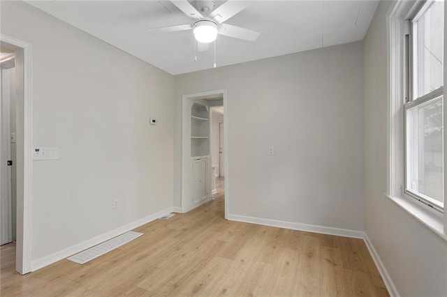 4433 N Jackson Ave, Kansas City, MO 64117 - unfurnished bedroom with baseboards and light wood-style floors