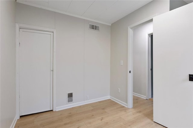 4433 N Jackson Ave, Kansas City, MO 64117 - spare room with baseboards, visible vents, and light wood finished floors
