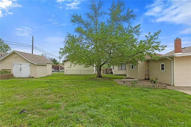 4433 N Jackson Ave, Kansas City, MO 64117 - view of yard with a storage shed and an outbuilding