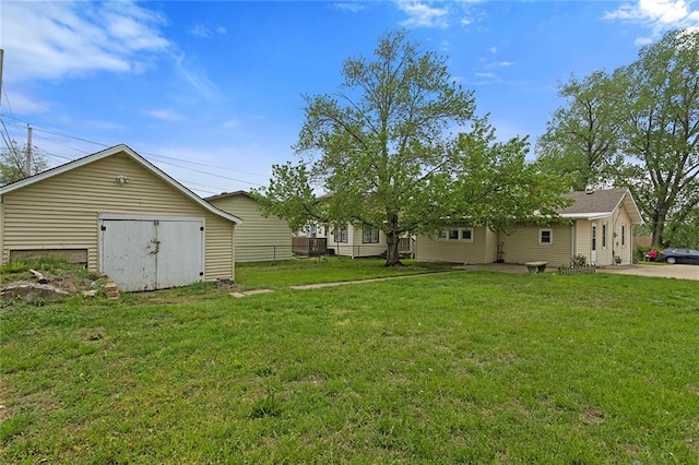 4433 N Jackson Ave, Kansas City, MO 64117 - view of yard with a garage, a storage unit, and an outdoor structure