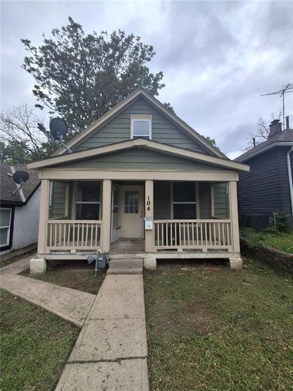 104 S 13th St, Kansas City, KS 66102 - shotgun-style home with covered porch