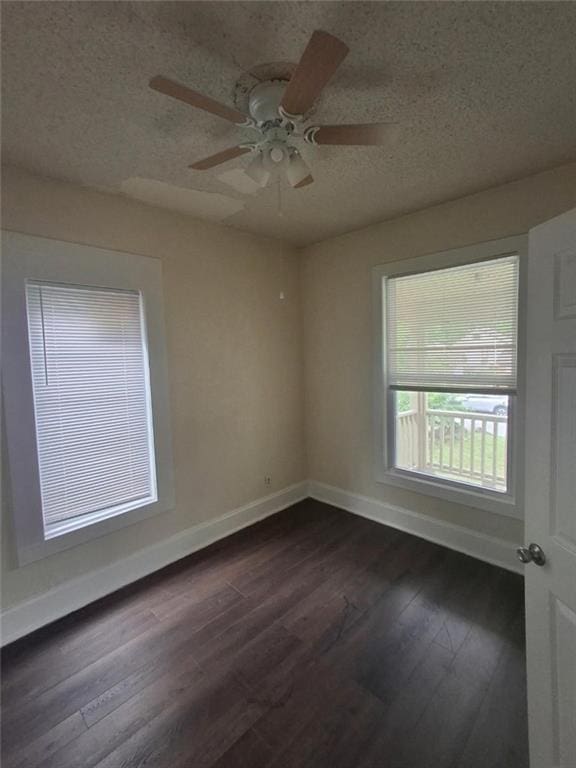 104 S 13th St, Kansas City, KS 66102 - empty room with baseboards, dark wood-type flooring, a ceiling fan, and a textured ceiling