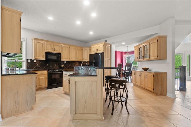 kitchen featuring light brown cabinets, black appliances, and recessed lighting