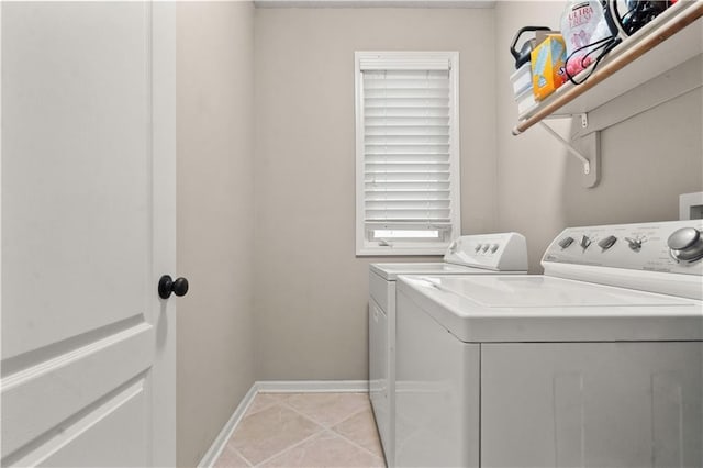 laundry room with baseboards, laundry area, washing machine and dryer, and light tile patterned flooring