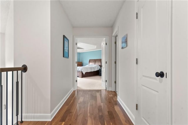 hall featuring baseboards and wood finished floors