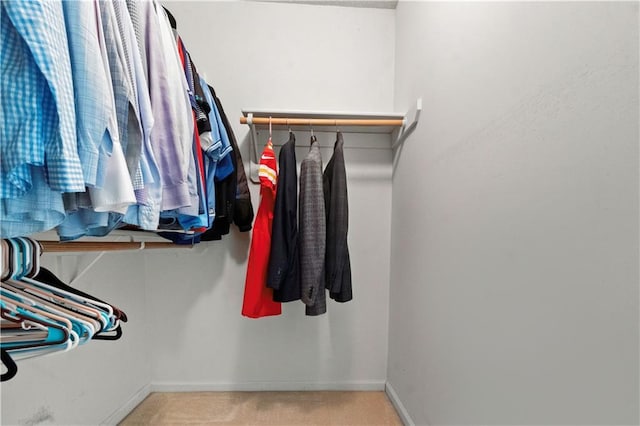 walk in closet with carpet floors
