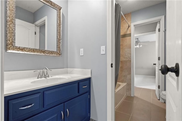 bathroom with ceiling fan, vanity, a textured ceiling, tile patterned floors, and bathing tub / shower combination