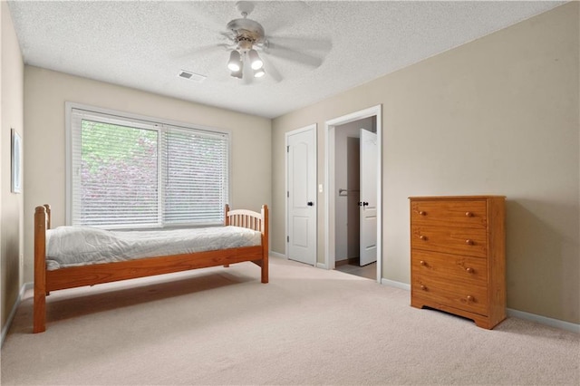 bedroom featuring baseboards, ceiling fan, carpet, and visible vents