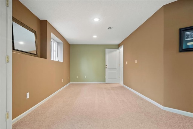 unfurnished room featuring recessed lighting, baseboards, and light carpet