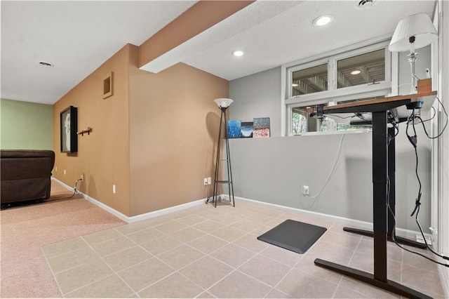 exercise area featuring baseboards, tile patterned flooring, recessed lighting, and visible vents