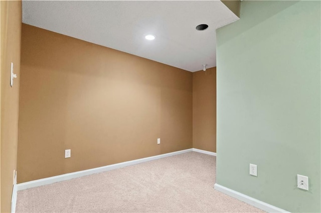 spare room featuring carpet floors, recessed lighting, and baseboards