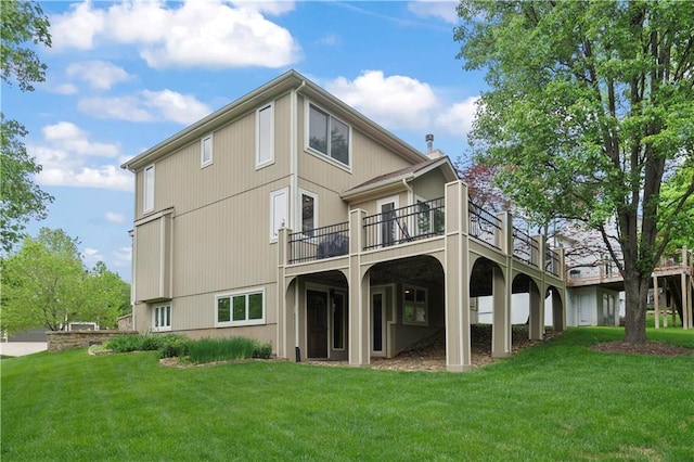 back of property featuring a lawn and a deck
