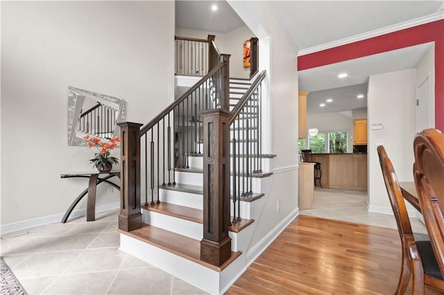 stairs featuring crown molding, recessed lighting, baseboards, and tile patterned flooring