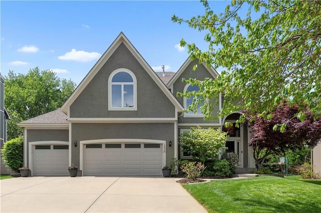 15920 Birch St, Overland Park, KS 66085 - view of front of home with a front lawn, concrete driveway, stucco siding, and a garage