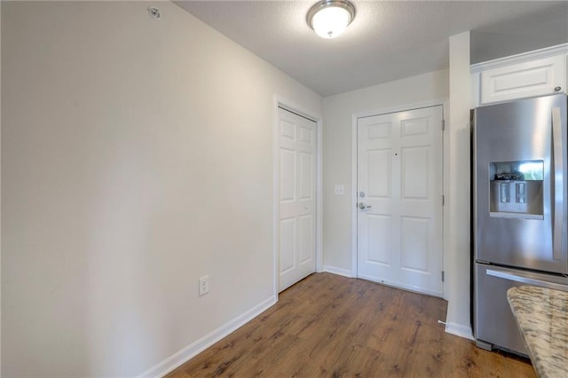 interior space with baseboards and wood finished floors