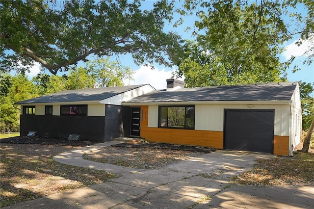 3907 Scherer Rd, Lees Summit, MO 64082 - view of front of property featuring an attached garage, a chimney, driveway, and brick siding