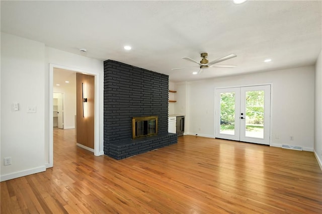 3907 Scherer Rd, Lees Summit, MO 64082 - unfurnished living room featuring a brick fireplace, a ceiling fan, light wood-style flooring, and visible vents