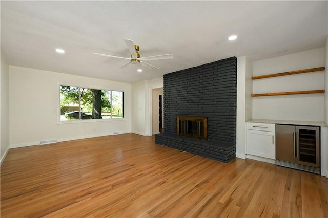 3907 Scherer Rd, Lees Summit, MO 64082 - unfurnished living room with a ceiling fan, visible vents, light wood finished floors, and wine cooler