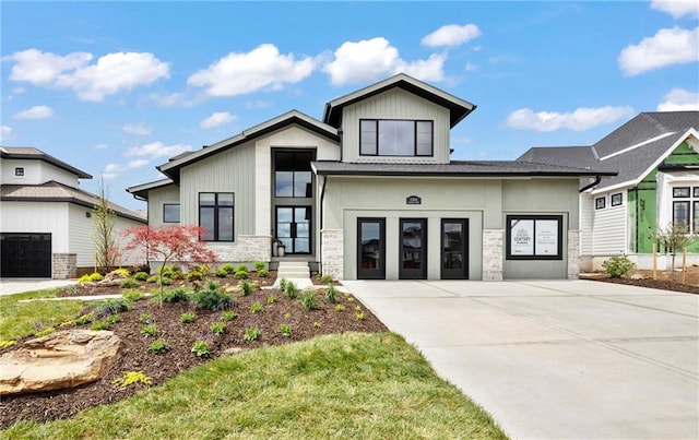 view of front facade with driveway and stone siding