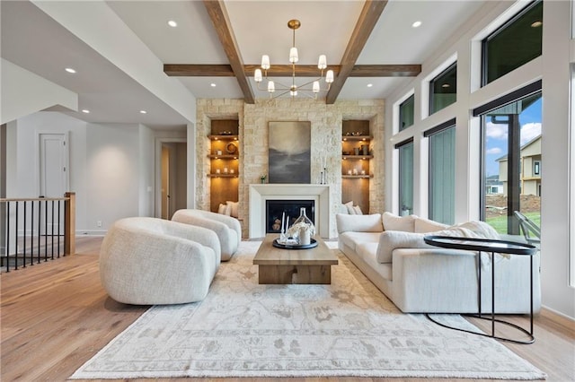 living room with a chandelier, built in features, baseboards, wood finished floors, and beamed ceiling