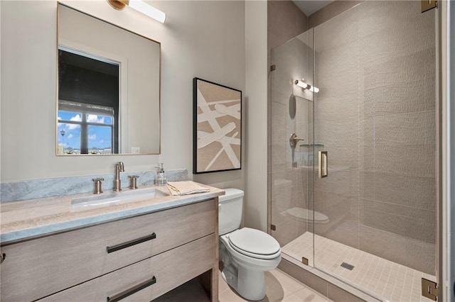 bathroom featuring toilet, a shower stall, and vanity
