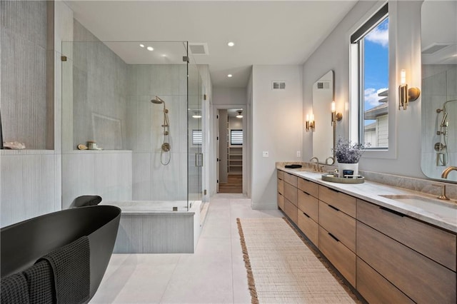 full bathroom featuring a sink, tile patterned flooring, a shower stall, a healthy amount of sunlight, and visible vents