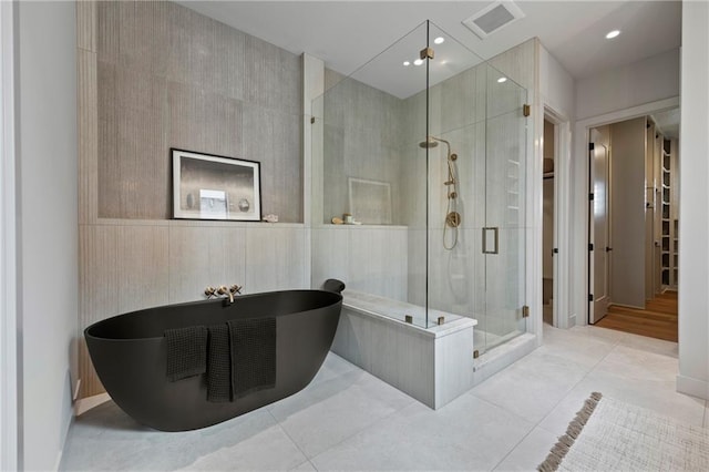 bathroom featuring a freestanding bath, tile patterned flooring, recessed lighting, visible vents, and a stall shower