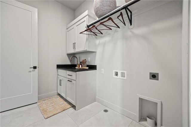 laundry room with cabinet space, a sink, hookup for a washing machine, electric dryer hookup, and baseboards