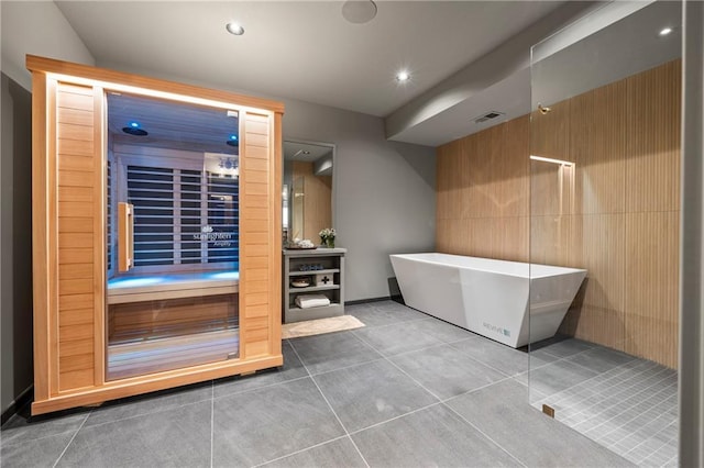bathroom with recessed lighting, a freestanding tub, visible vents, and tile patterned flooring