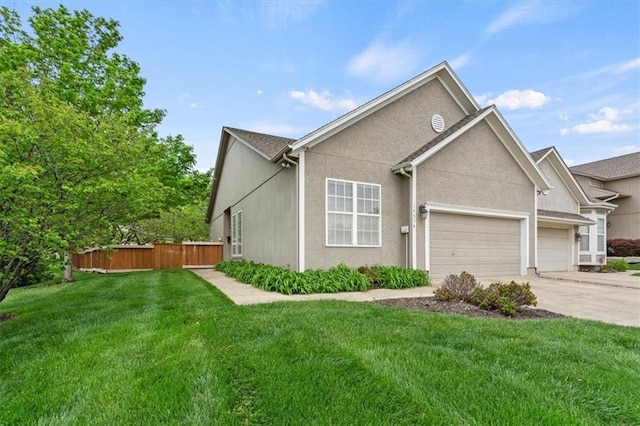 view of front facade featuring a garage, a front lawn, fence, stucco siding, and driveway
