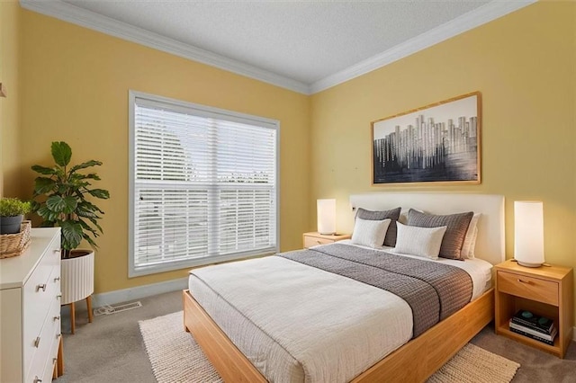 carpeted bedroom with visible vents, ornamental molding, baseboards, and a textured ceiling