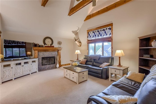 living room featuring light colored carpet, lofted ceiling with beams, and a tile fireplace