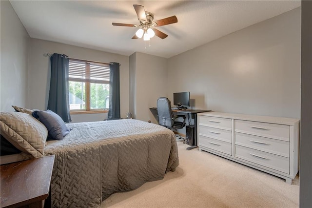 bedroom with light carpet and a ceiling fan
