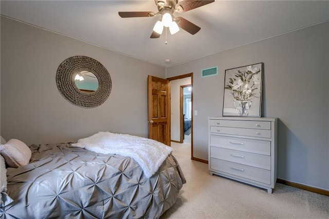 bedroom featuring a ceiling fan, light colored carpet, and visible vents